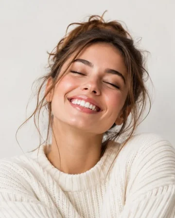 Smiling woman in a cream knit sweater