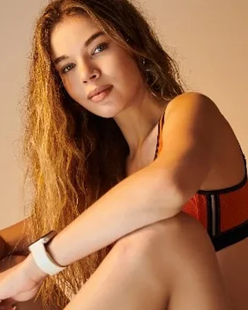 Woman in sportswear sitting on a studio box