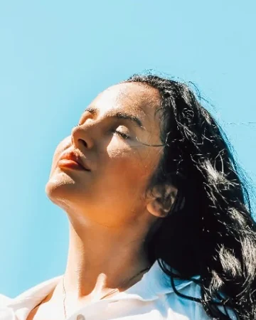 Woman in a white top enjoying the sun