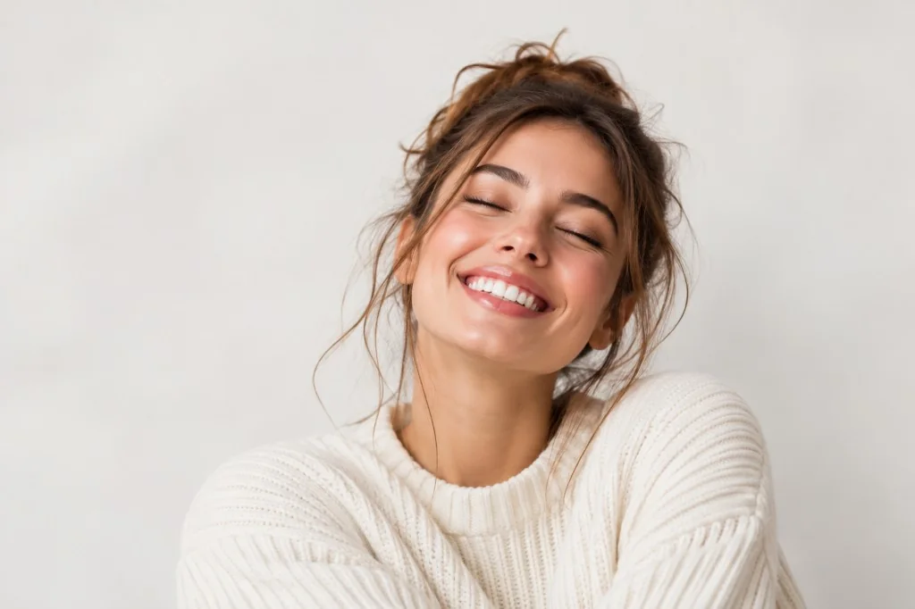 Happy customer in a cream knit sweater smiling after a great Shopify order